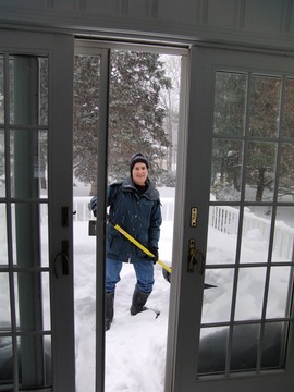 Kathy shovels the deck