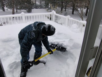 Kathy shovels the deck
