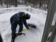 Kathy shovels the deck