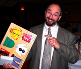 Ben is amused by Vidya's gift of the basic skills board.  In case he forgets...