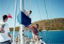 Erik belays Ross, as Kathy and Ben assist in fixing a batten.